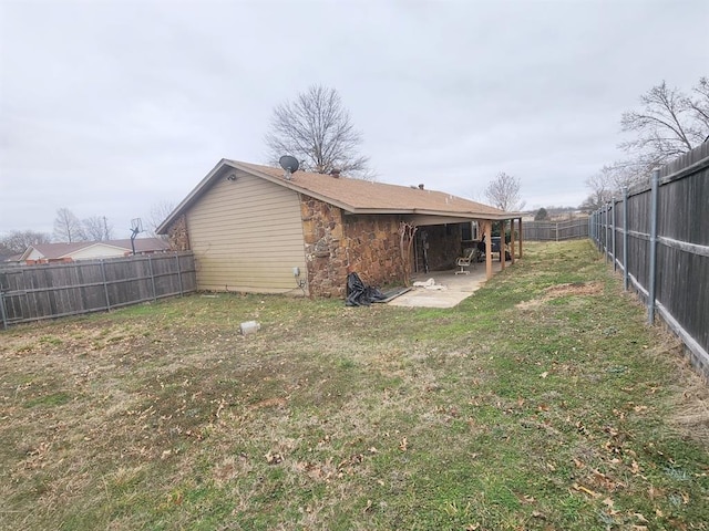 view of yard featuring a patio area and a fenced backyard