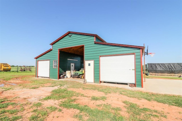 detached garage featuring fence