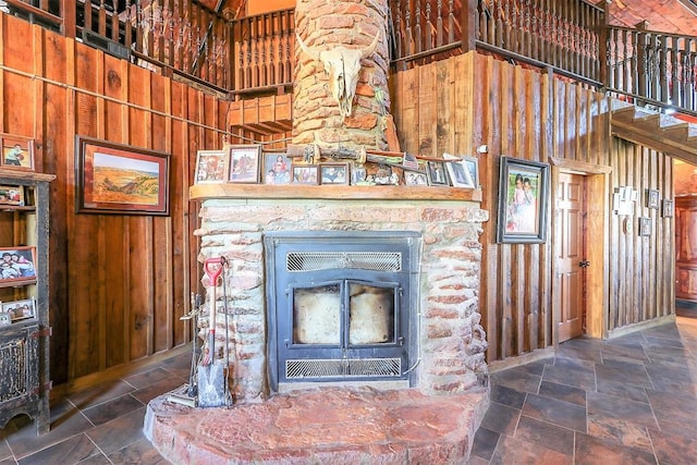 room details featuring a wood stove and wood walls