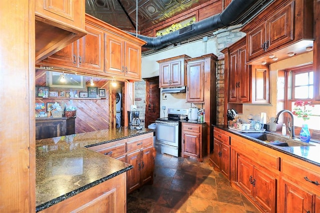 kitchen featuring stone tile floors, a sink, stainless steel electric stove, dark countertops, and an ornate ceiling