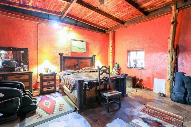 bedroom featuring vaulted ceiling with beams, wooden ceiling, and a textured wall