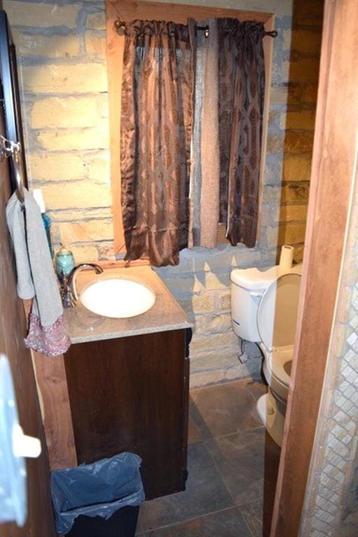 bathroom featuring toilet and vanity