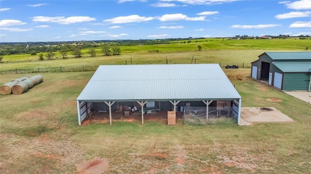 view of outbuilding with a rural view and an outdoor structure