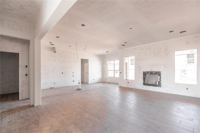 unfurnished living room featuring light wood-style flooring and a fireplace