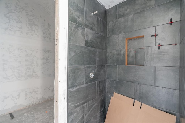 full bath with a tile shower