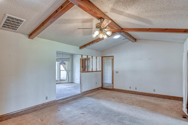 spare room with baseboards, visible vents, lofted ceiling with beams, a textured ceiling, and carpet flooring