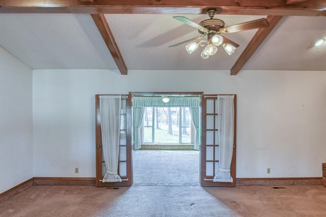 unfurnished room featuring visible vents, a textured ceiling, baseboards, and carpet