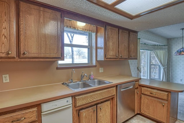 kitchen with a wealth of natural light, dishwasher, and a sink