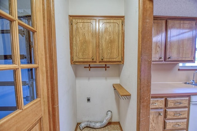 laundry area with cabinet space and hookup for an electric dryer