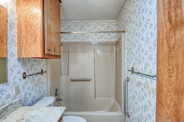 full bath with vanity, washtub / shower combination, wallpapered walls, a textured ceiling, and toilet