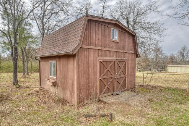 view of barn with fence