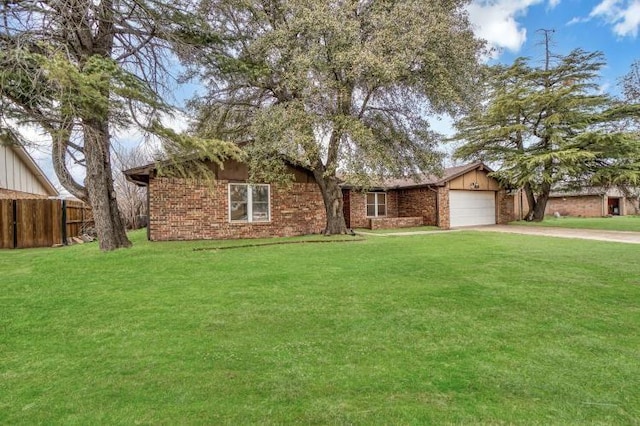 ranch-style home featuring an attached garage, concrete driveway, a front yard, and fence