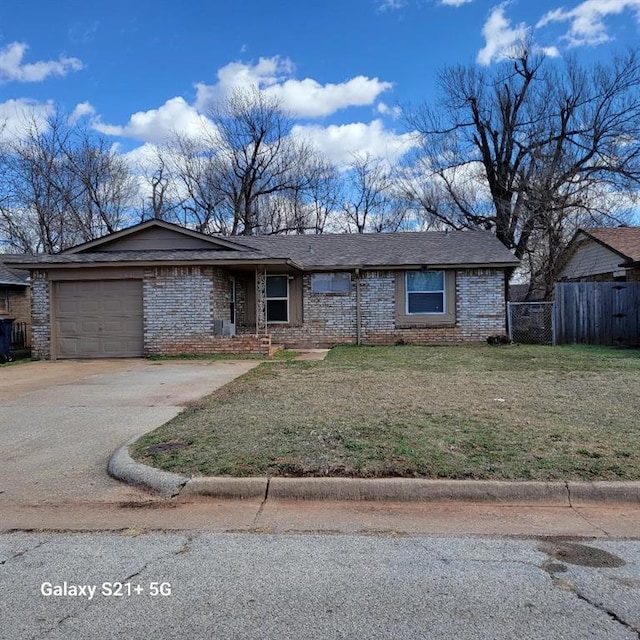 view of front of property with concrete driveway, an attached garage, fence, a front yard, and brick siding