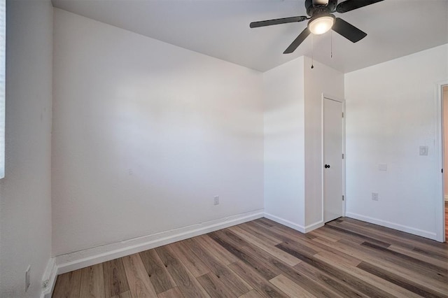 unfurnished room with ceiling fan, baseboards, and wood finished floors