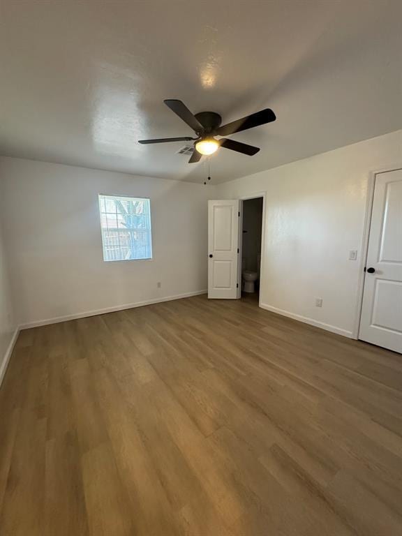 unfurnished bedroom featuring a ceiling fan, baseboards, and wood finished floors