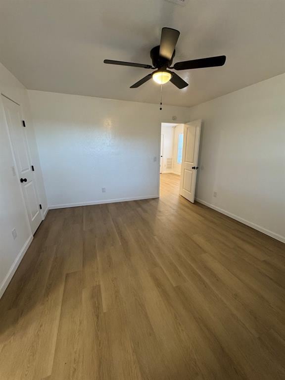 empty room with wood finished floors and baseboards