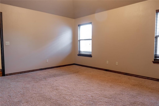 unfurnished room featuring carpet flooring and baseboards