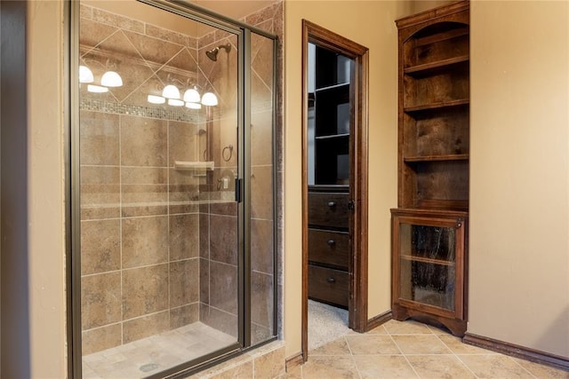 bathroom featuring a stall shower, baseboards, and tile patterned floors