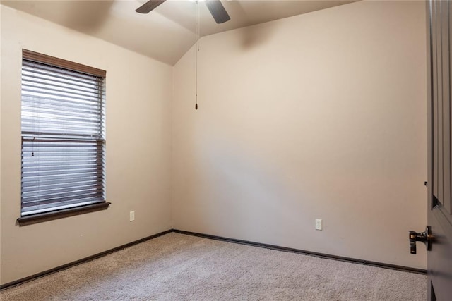 unfurnished room featuring lofted ceiling, carpet flooring, a ceiling fan, and baseboards