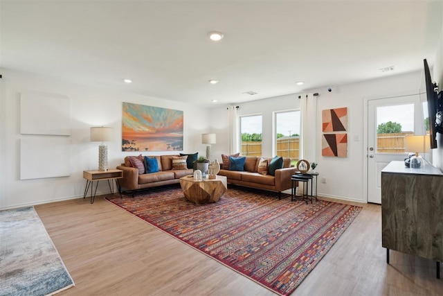 living area featuring recessed lighting, baseboards, and wood finished floors