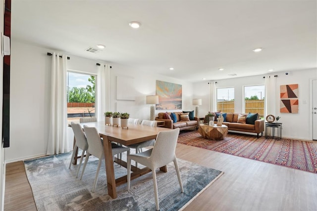 dining space with visible vents, wood finished floors, and recessed lighting