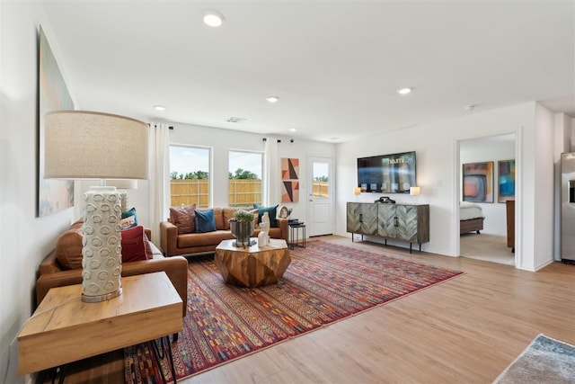 living area with wood finished floors and recessed lighting