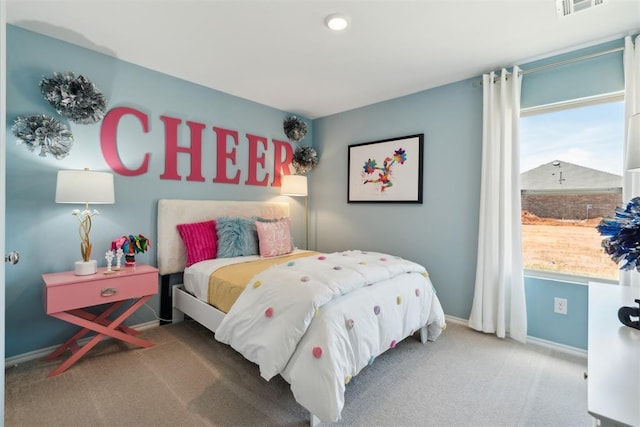 carpeted bedroom with visible vents and baseboards