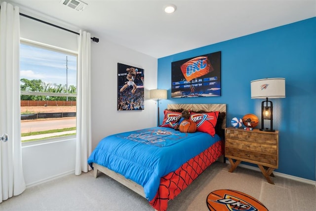 bedroom with carpet floors, visible vents, and baseboards