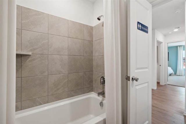 bathroom with shower / tub combo and wood finished floors