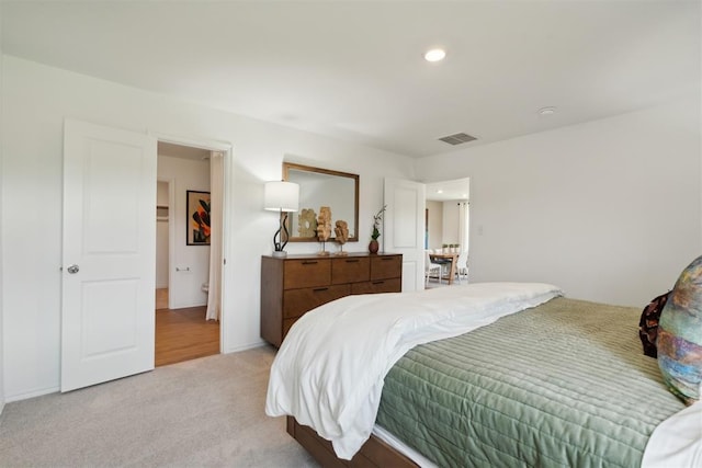 bedroom featuring light carpet, visible vents, and recessed lighting