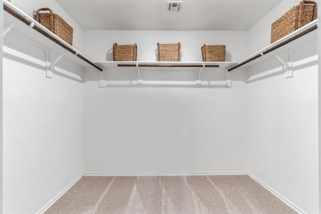 spacious closet with carpet floors and visible vents