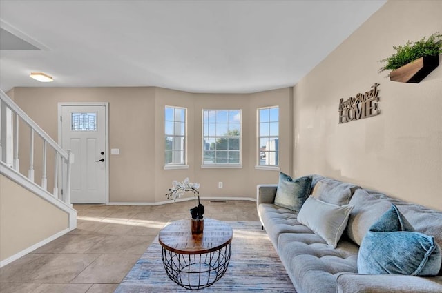 tiled living area with stairs and baseboards