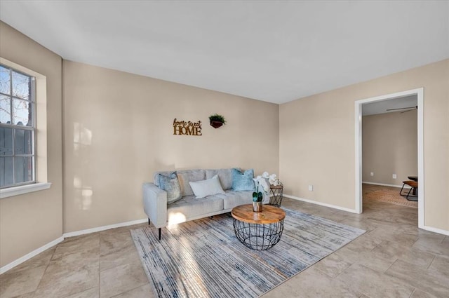 living area featuring baseboards