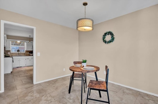 dining area featuring baseboards