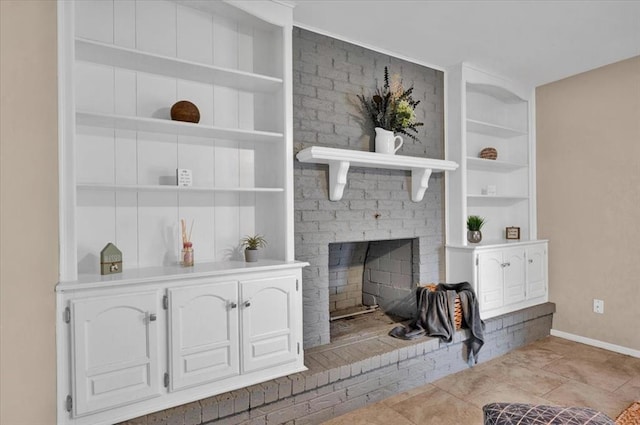 tiled living room featuring baseboards, built in shelves, and a brick fireplace