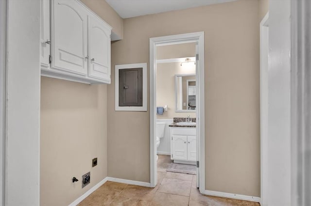 laundry room with a sink, electric panel, cabinet space, baseboards, and hookup for an electric dryer