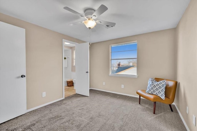 sitting room with carpet flooring, a ceiling fan, and baseboards