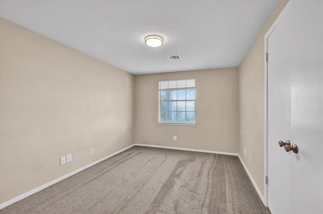 empty room with visible vents, carpet flooring, and baseboards