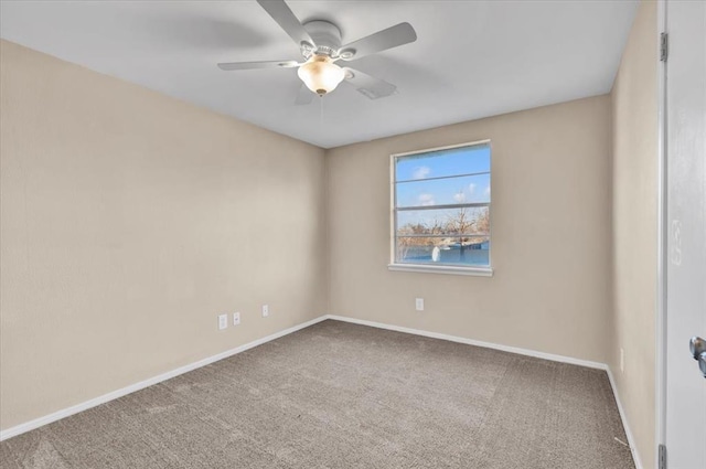 spare room featuring a ceiling fan, baseboards, and carpet floors