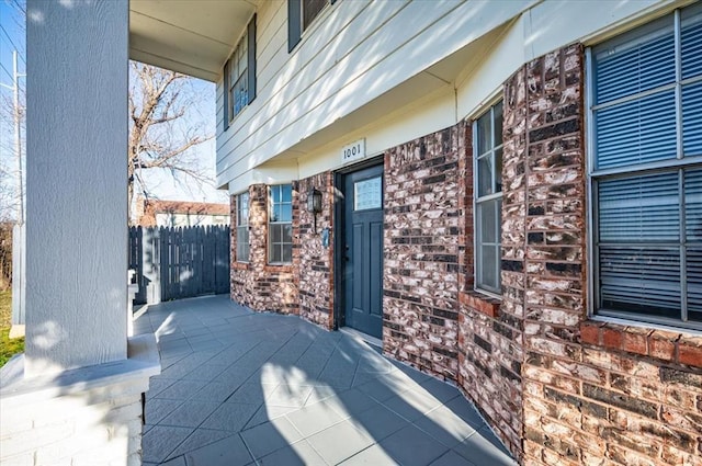 view of patio / terrace with a porch and fence