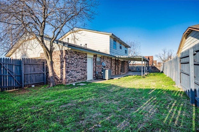 view of yard with central AC unit and a fenced backyard