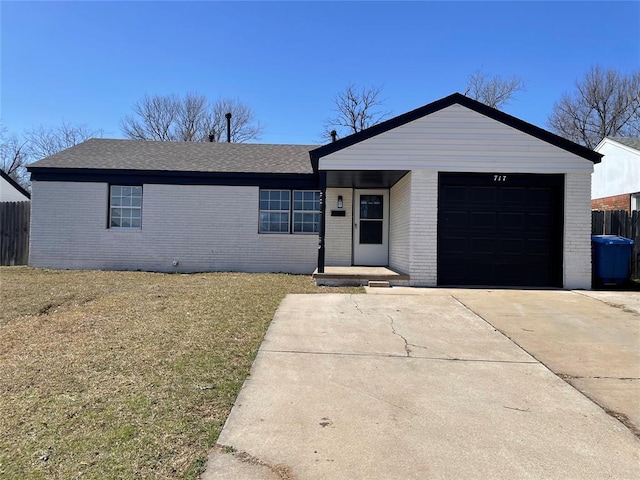 ranch-style home featuring brick siding, driveway, and fence