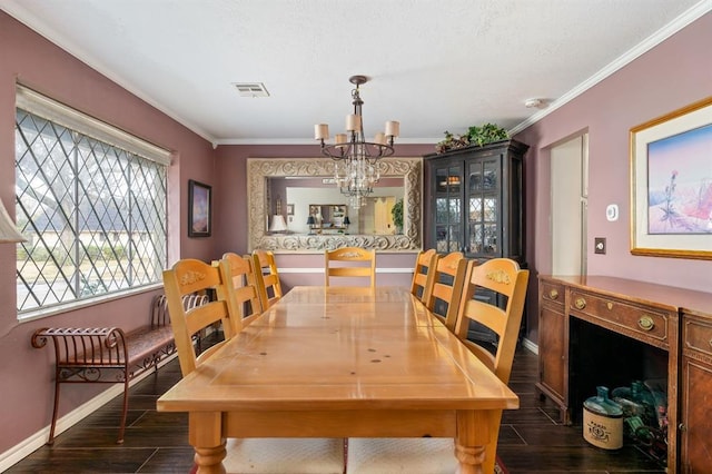 dining room with visible vents, dark wood-style floors, a chandelier, and ornamental molding