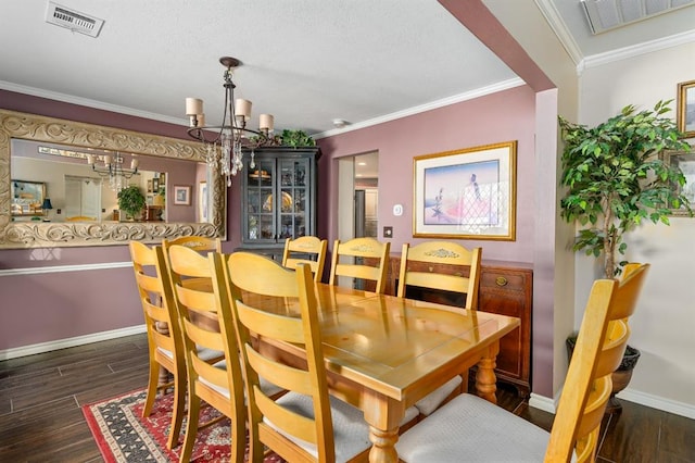 dining space featuring visible vents, wood finished floors, and crown molding