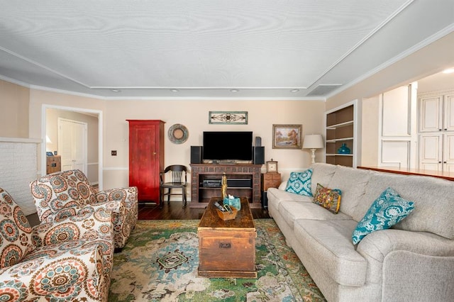 living area with visible vents, built in shelves, and wood finished floors