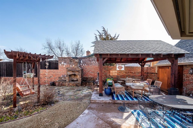 view of patio with a gazebo, an outdoor living space with a fireplace, outdoor dining area, and fence