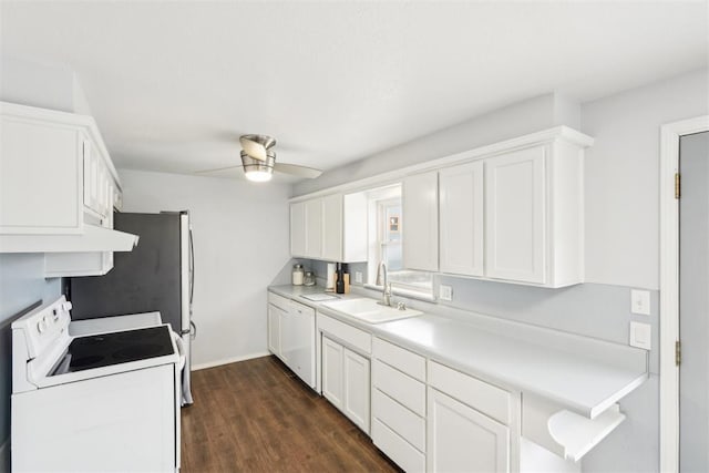 kitchen featuring dark wood-type flooring, white appliances, white cabinetry, and a sink