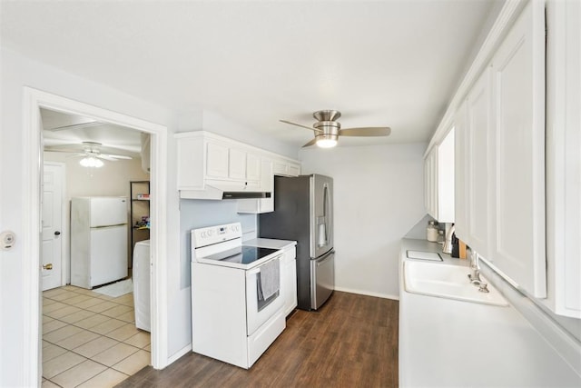 kitchen with white appliances, a ceiling fan, white cabinets, and a sink