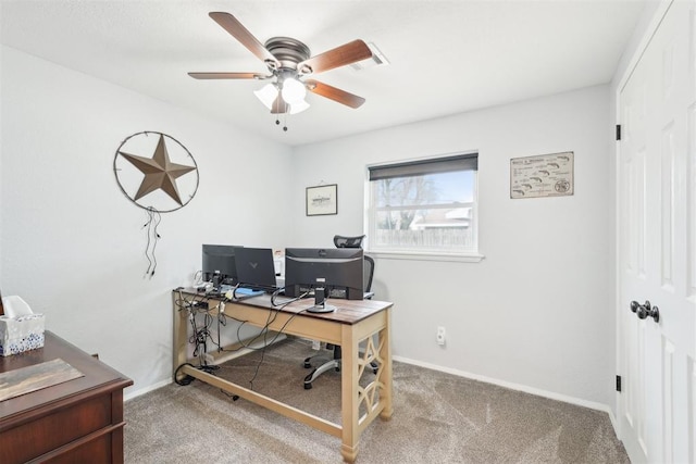 carpeted office featuring baseboards and a ceiling fan