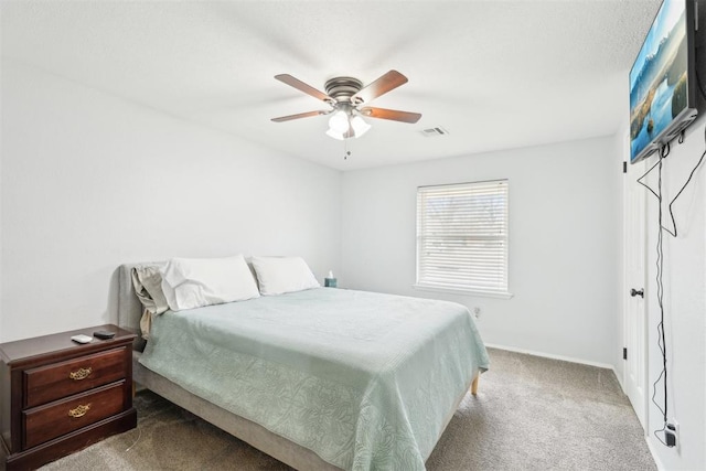 carpeted bedroom featuring ceiling fan and visible vents